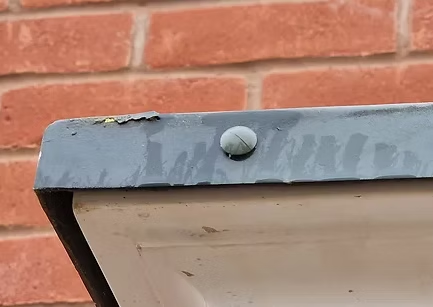 Loose flashing and paint defect on external metalwork